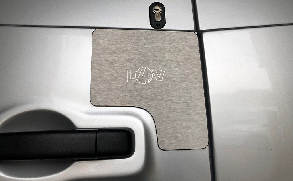 External lock shield fitted over a van door handle